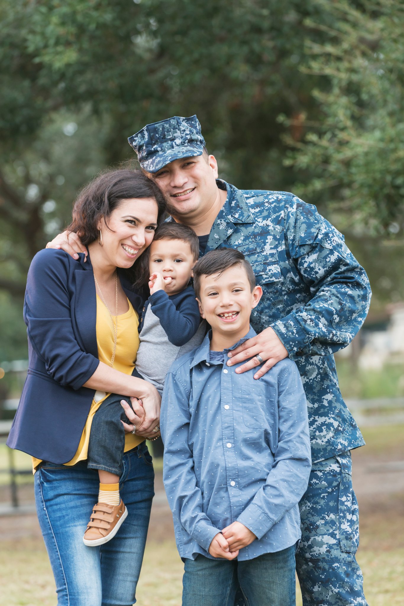 Active-duty military family smiling together outside