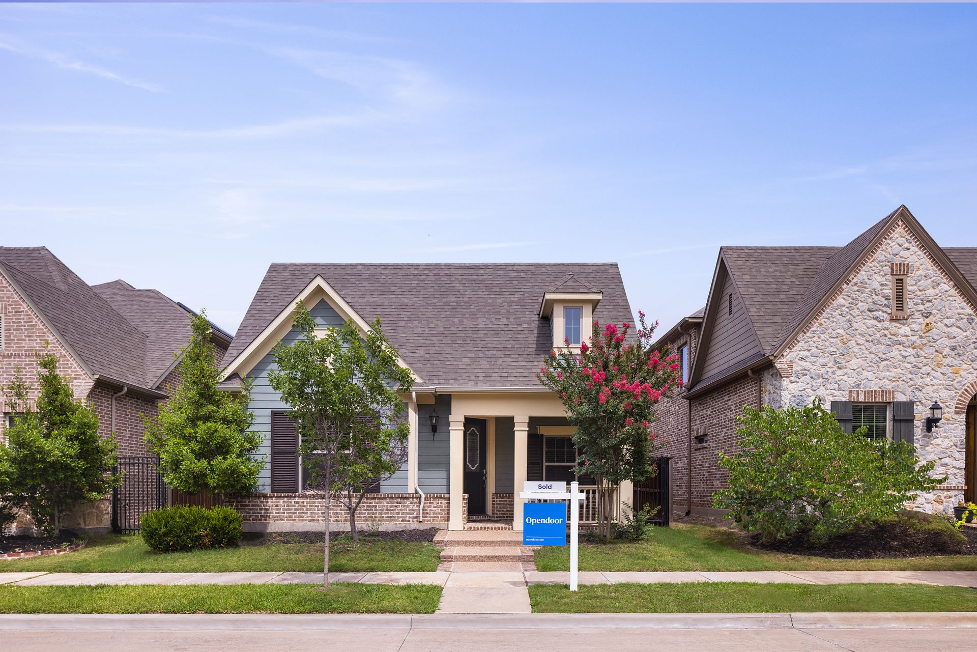 A home that's been sold to opendoor in the middle of two other homes