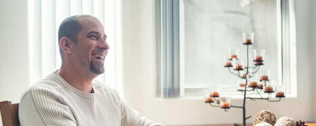 Keith Westergaard seated at a table in his home