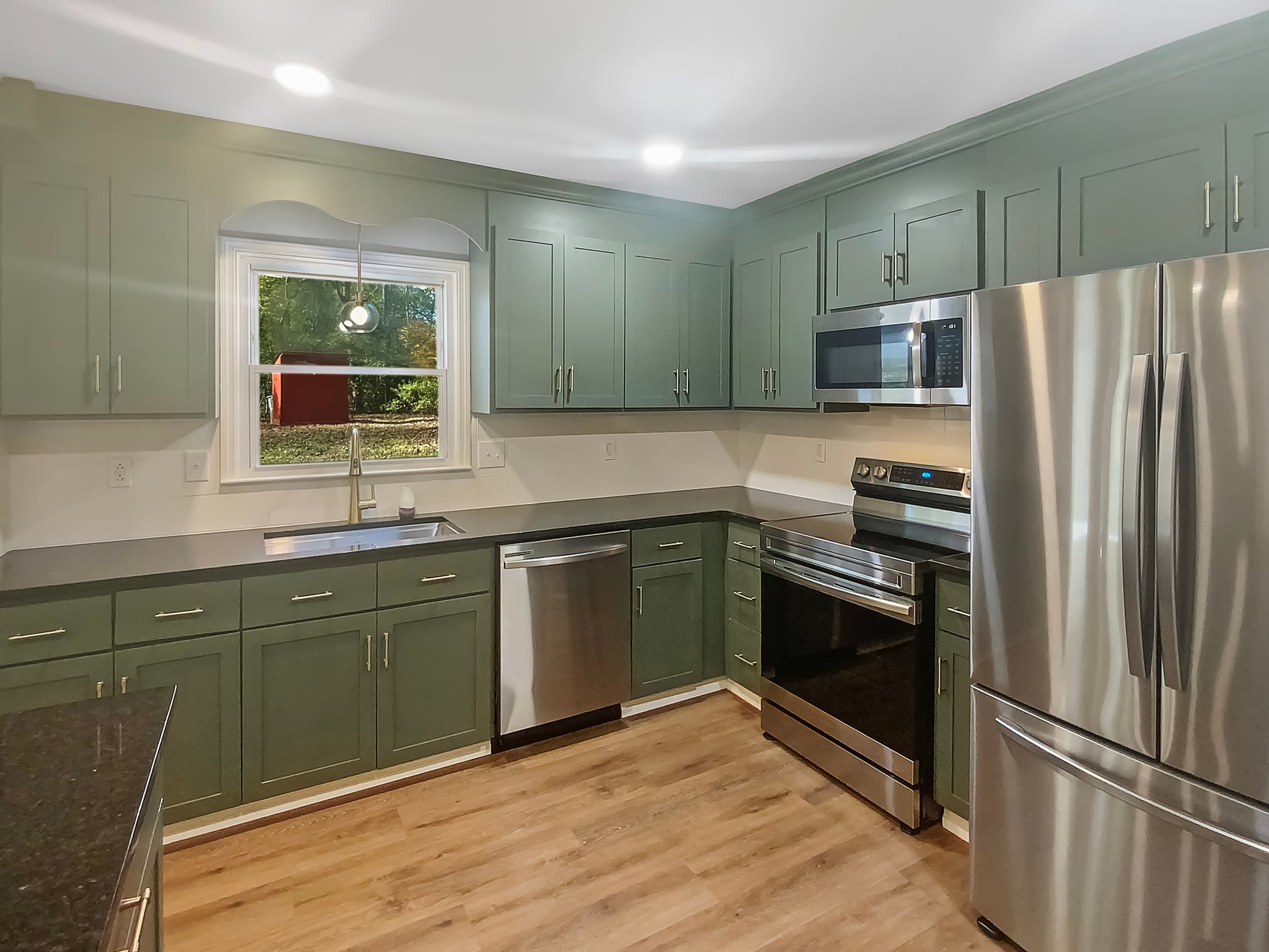 These light blue base cabinets in Charlotte use Sherwin Williams' "SW 6218 Tradewind".