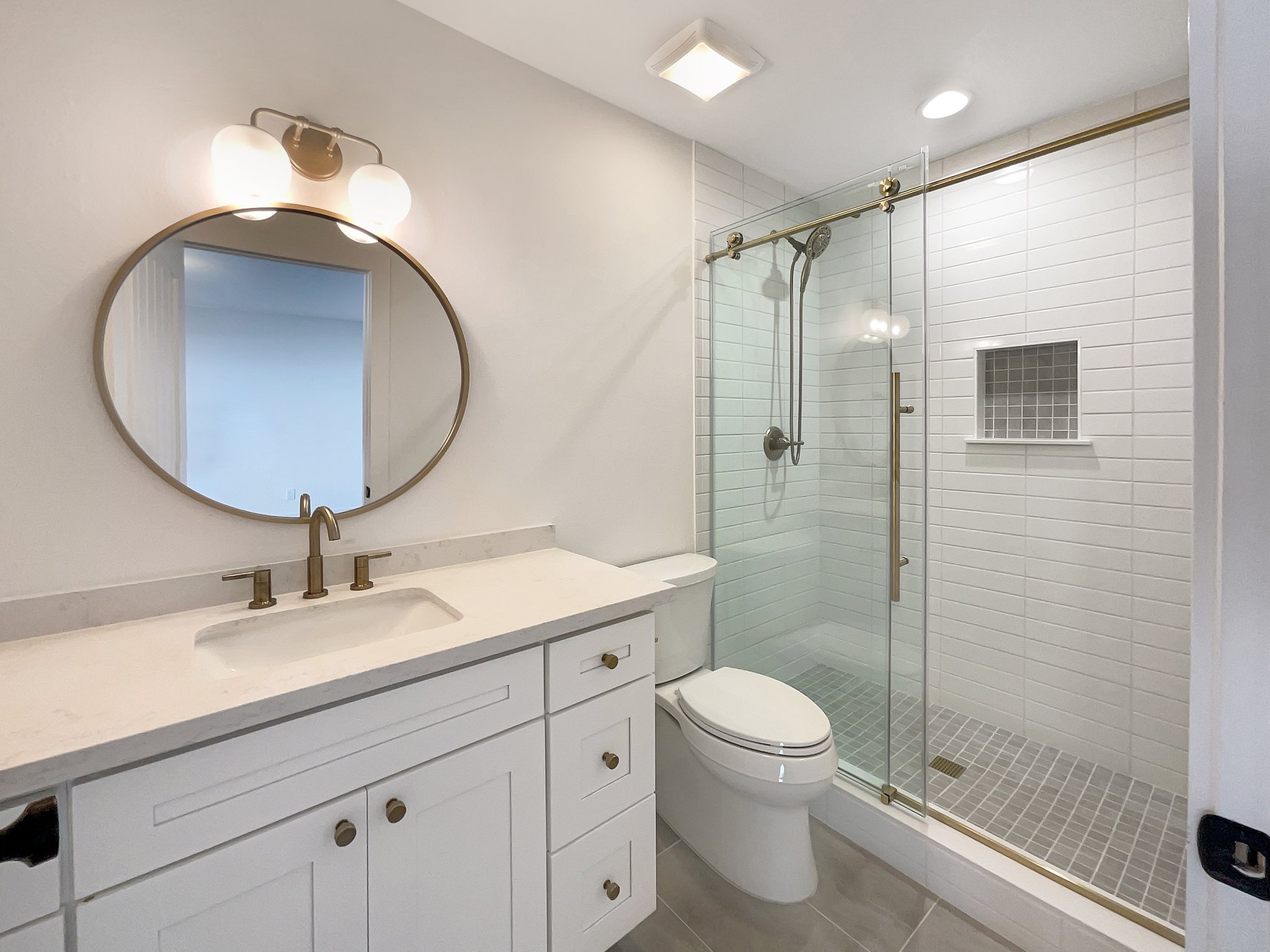 San Diego: Emser Tile in Manhattan for the floor and Ice for the shower wall, and Delta champagne bronze fixtures.