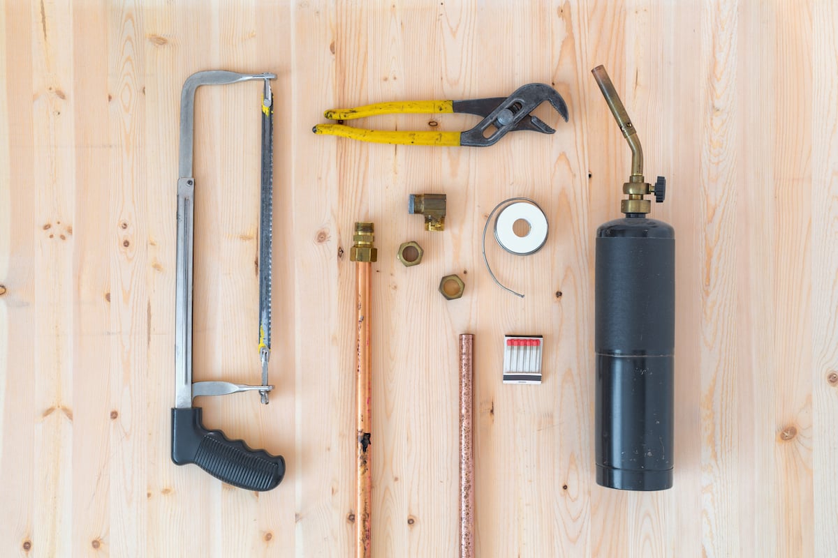 Collection of plumbing repair tools and supplies