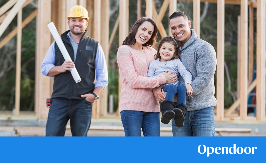 A production home builder framing a new construction house exterior on a suburban lot.