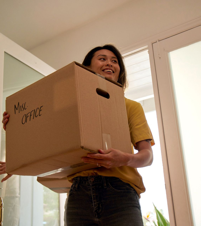 Moving boxes in a living room after a home purchase