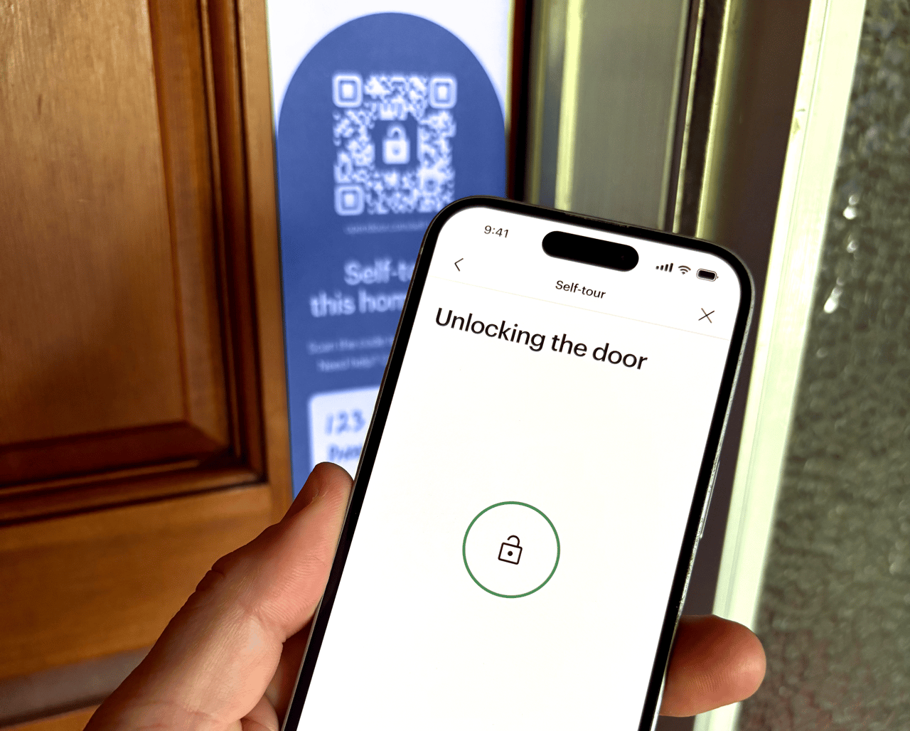 A buyer using the Opendoor app to enter a home for a self-tour.
