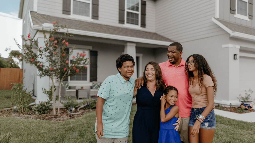 Family standing outside their home
