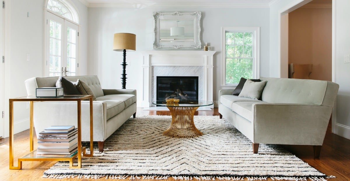 Neatly staged living room with plants and light neutral decor prepared for an open house showing