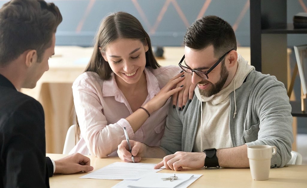 Homeowners reviewing documents at a closing table