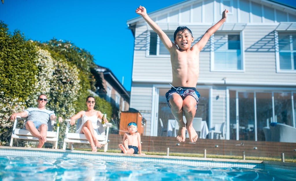 Single-family home exterior with a backyard pool