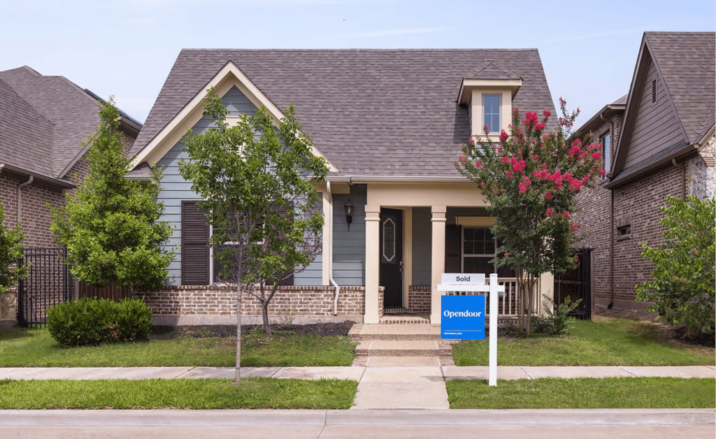 Suburban home with an Opendoor Sold sign in the front yard